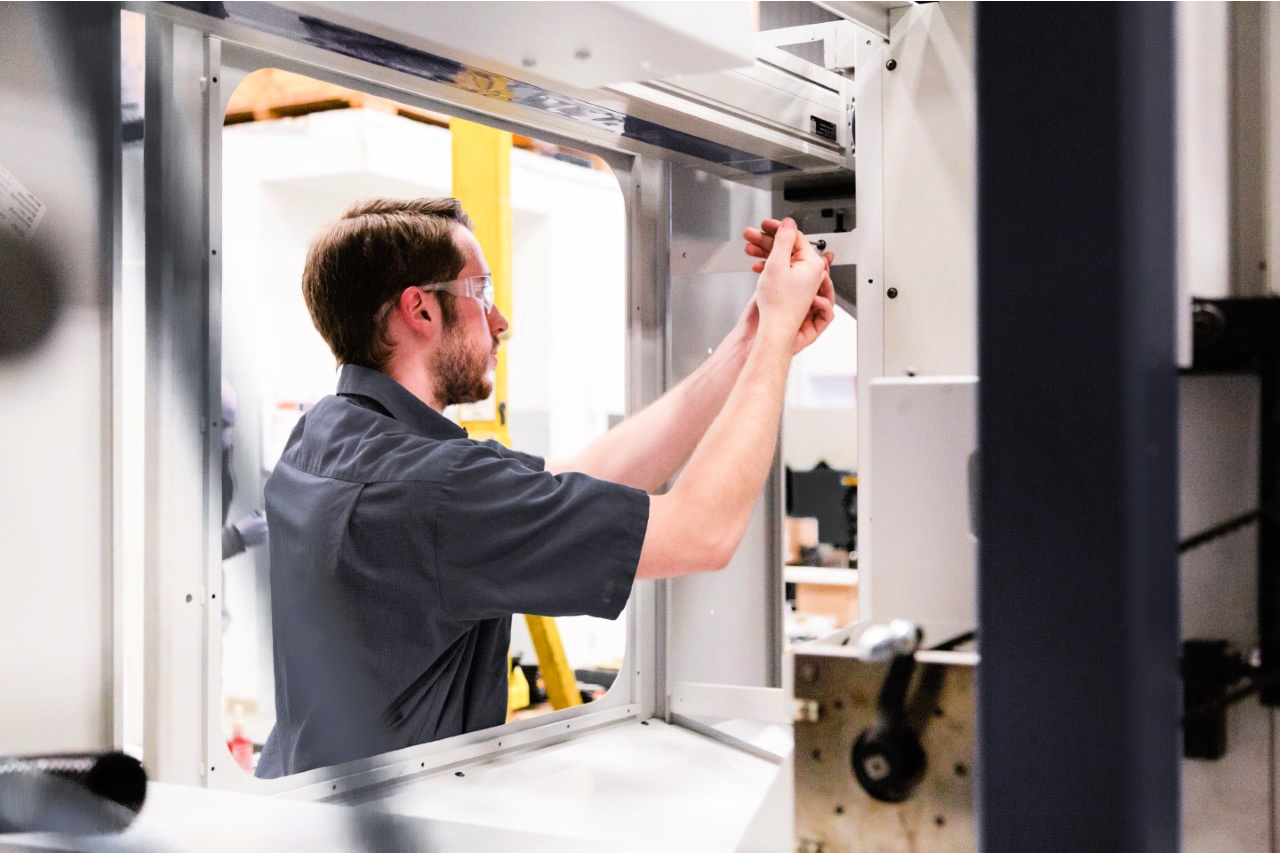 Service engineer Jack Jaeger works on a machine for a customer