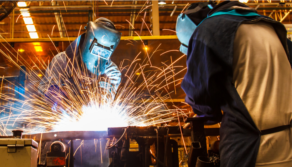 two welders make sparks fly, showing the benefit of training in the skilled trades