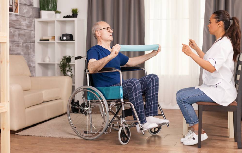 A home healthcare provider conducts a therapy session with a patient.