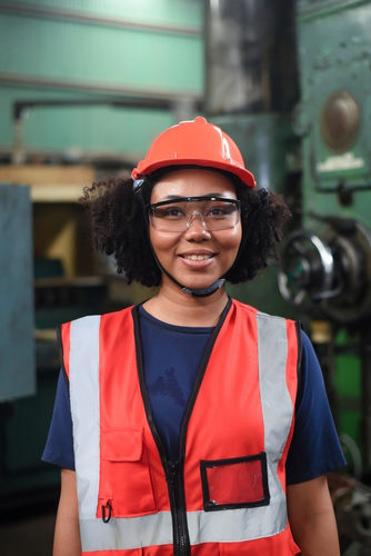 Young Black woman in safety gear in a manufacturing setting