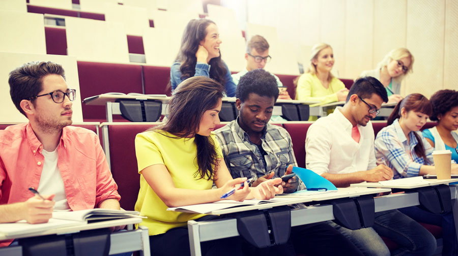 College students take notes and listen in class