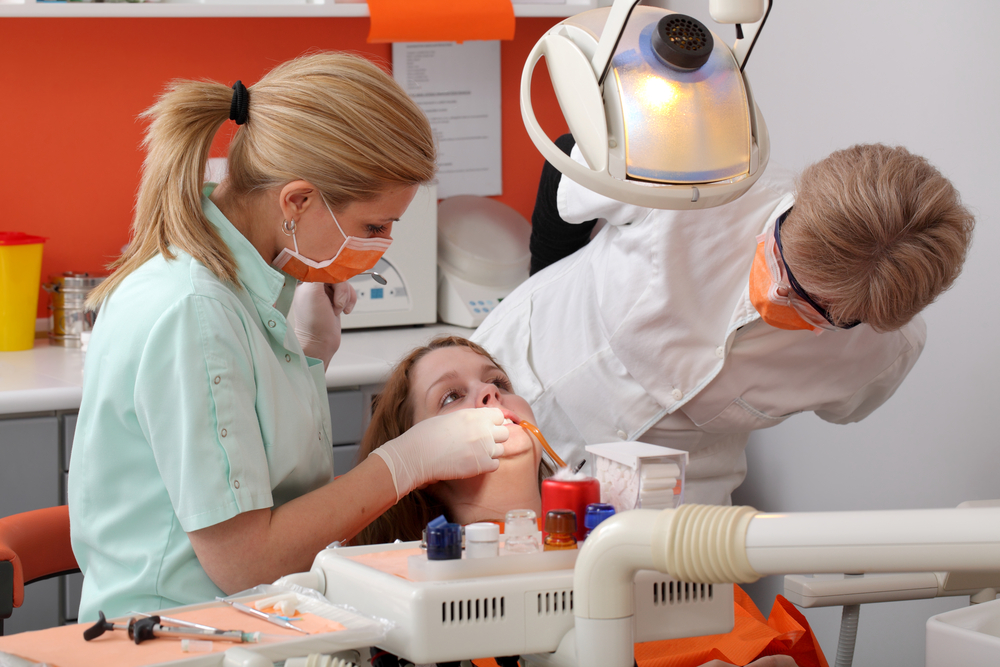 Dental hygienist gets on the job training with an expert