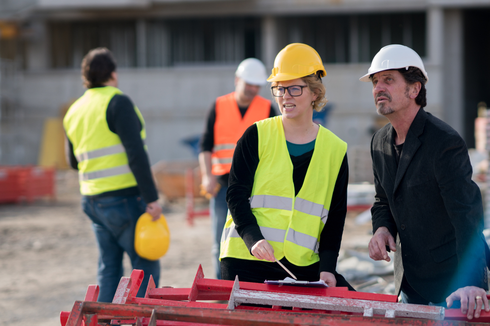 Female engineer and male construction manager work on a construction site for infrastructure work