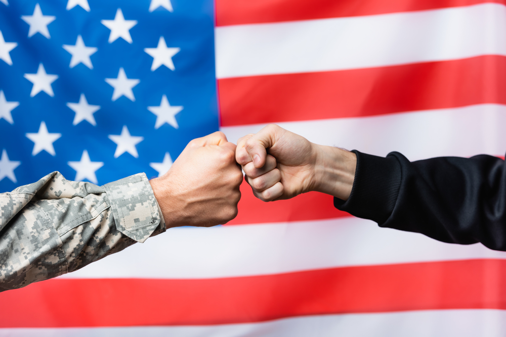 Fist bump between military person and civilian, why training for veterans matters