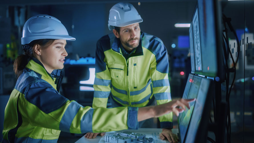 White male trainer works with younger white female in an industrial setting. Example of micro credentials as a solution for the skills gap.