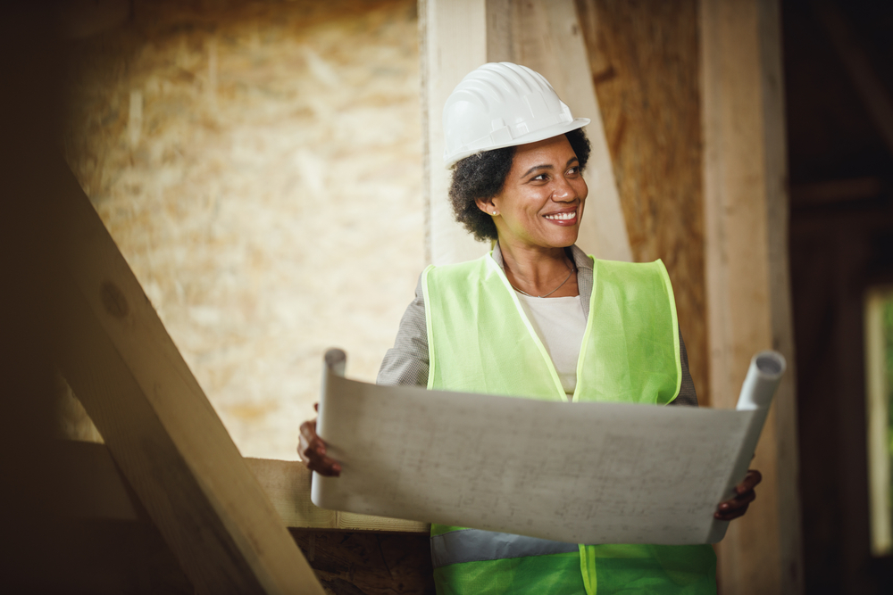 Black female checking plans at the construction site of a new house. It's a myth that the trades aren't for women