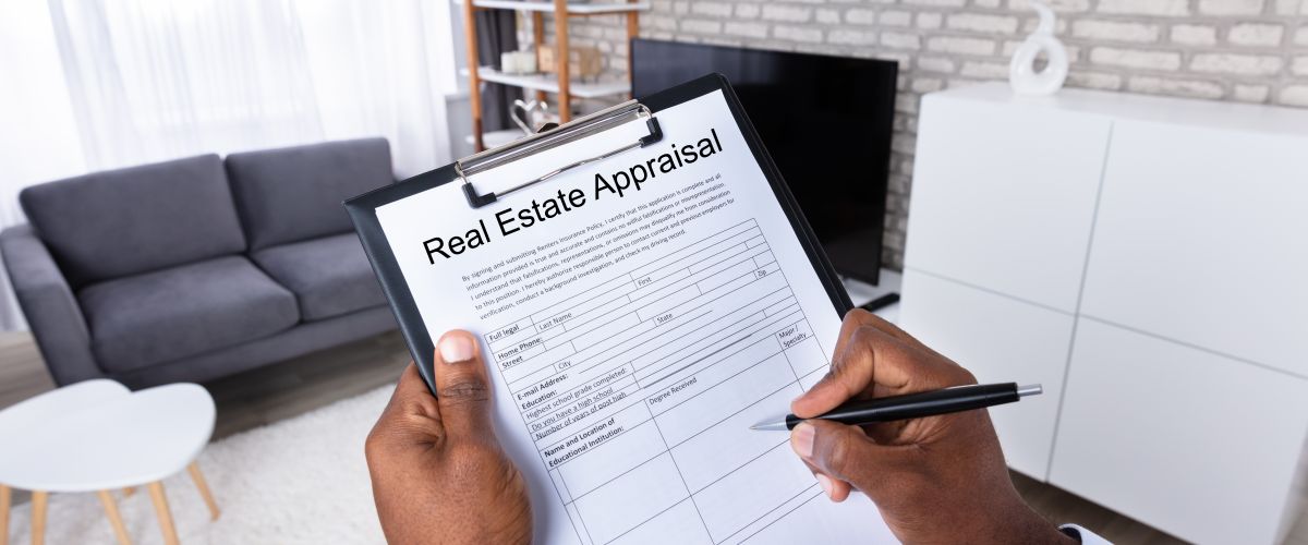 A real estate appraiser completes a form that notes the condition of a house 
