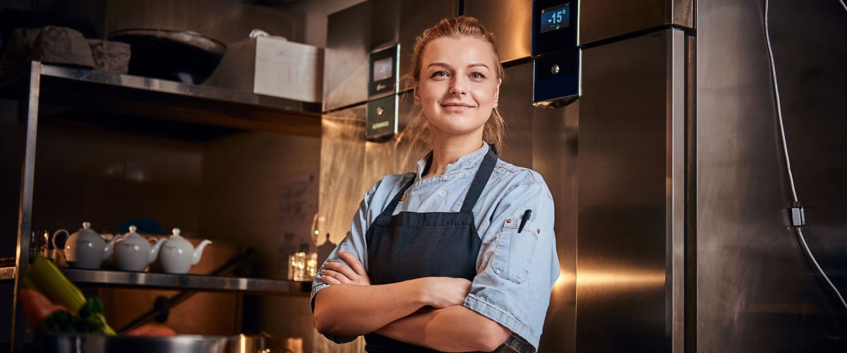 Young female chef takes a break from food prep 