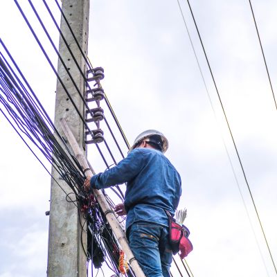 A fiber optics technician connects a network