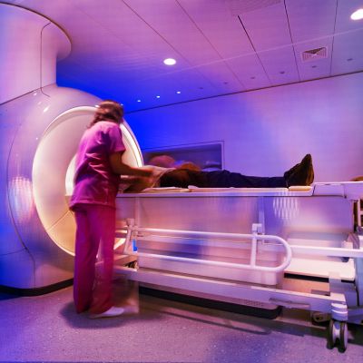 MRI technicians prepare a patient for a scan