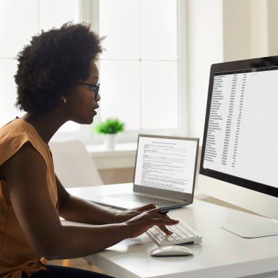 Young black female bookkeeper works on a computer crunching numbers