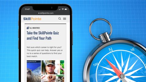 mobile phone opened to SkillPointe.com beside a compass