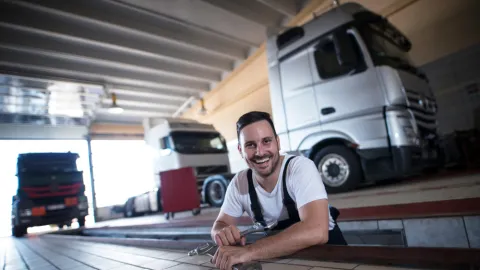 Diesel mechanic in vehicle inspection pit of a repair shop, example of diesel mechanic training