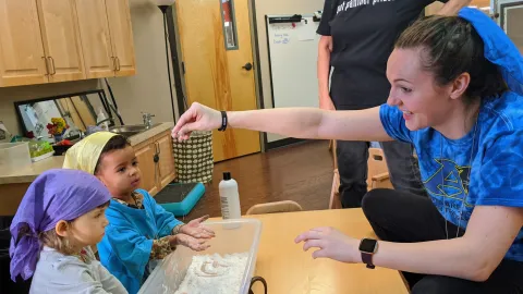 Meredith Lipman, preschool teacher, plays with students Amber and Robbie