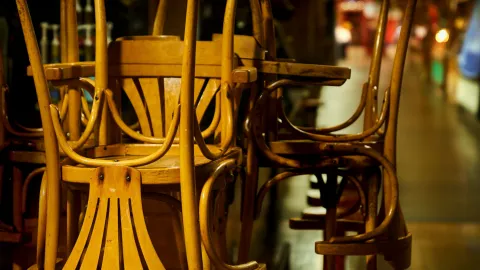 closed restaurant with chairs turned upside down on the tables