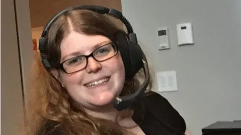 Robin O’Neill, broadcast engineer, works at a computer 