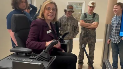 Dr. Rebecca Corbin tries the Caterpillar simulation