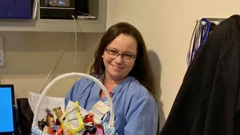 Cardiovascular technologist Shaun Foust holds a thank-you basket sent to the team for working during the COVID-9 pandemic