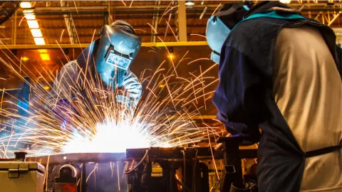 two welders make sparks fly, showing benefit of getting trained in the skilled trades