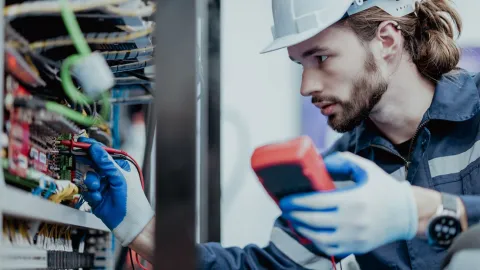 male electrician troubleshoots an electrical problem