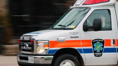 An ambulance drives down the road toward an emergency medical situation.