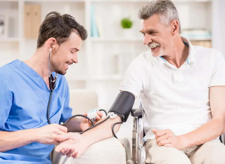 A medical assistant takes a patient’s blood pressure