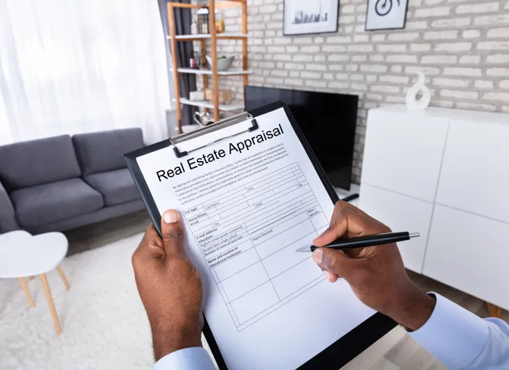 A real estate appraiser completes a form that notes the condition of a house