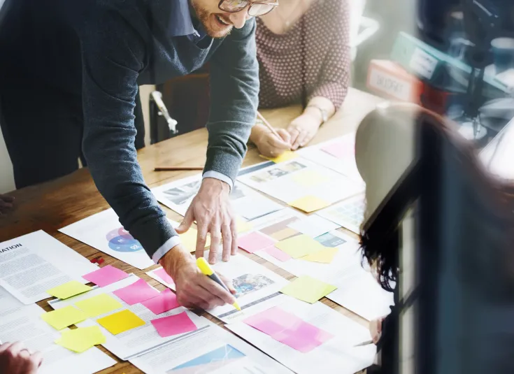 A technical writer meets with a team to brainstorm ideas