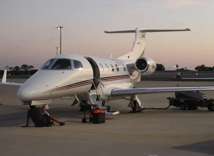 An aircraft mechanic works on a plane