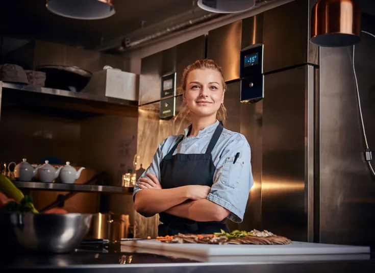 Young female chef takes a break from food prep 