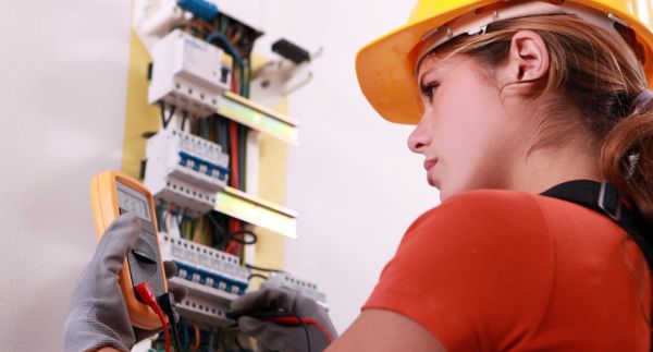 Female electrician works on an electrical project