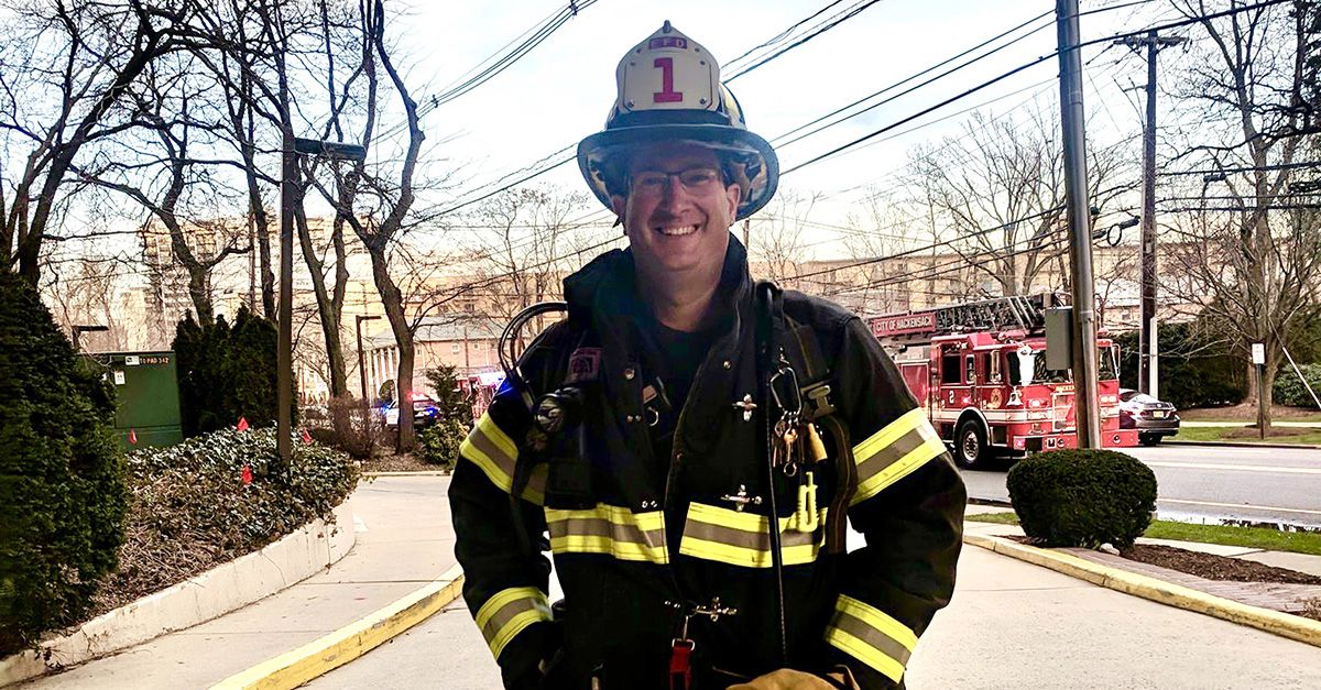Firefighter Jeffrey Kaplan of New Jersey stands in front of a fire engine in his gear