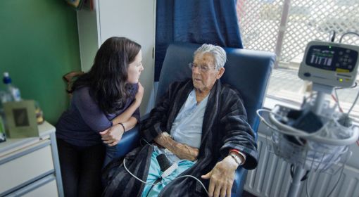 A social services assistant checks on an elderly client