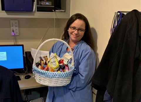 Cardiovascular technologist Shaun Foust holds a thank-you basket sent to the team for working during COVID-19