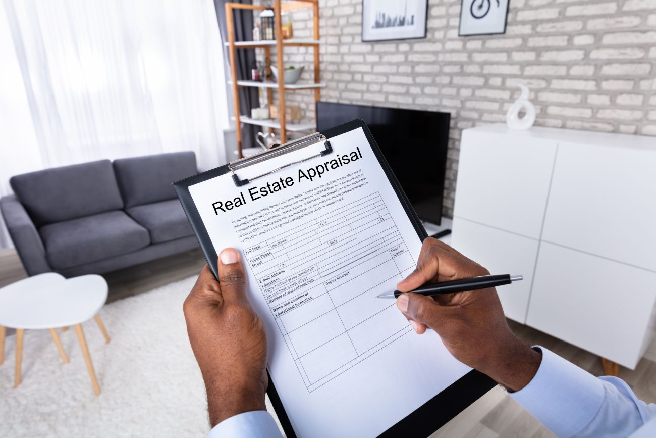 A real estate appraiser completes a form that notes the condition of a house 