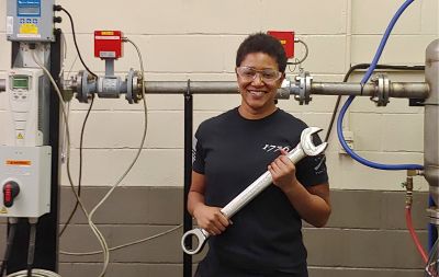 Electrical and electronics engineering technician Tracy Wilson with a large wrench