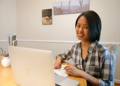 Pauline Lu, graphic designer, working on her computer