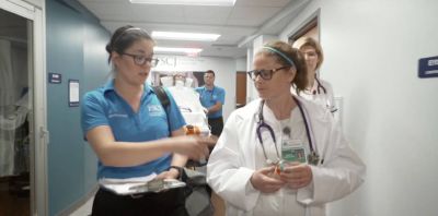 Two FSCJ nursing students walk together down a hospital hallway.