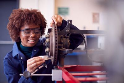 Young black teen works with a wheel in a vocational tech center. Example of micro credentials and how they open up new pathways