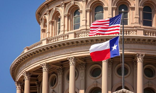 U.S. and Texas flags fly at the Texas State Capitol in Austin