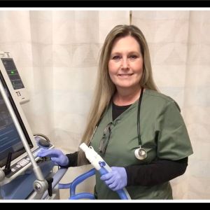 Respiratory therapist Kimby Powell with a ventilator