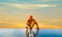 A solar energy technician installs solar panels