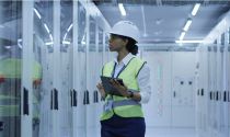 Female power plant operator inspecting equipment 